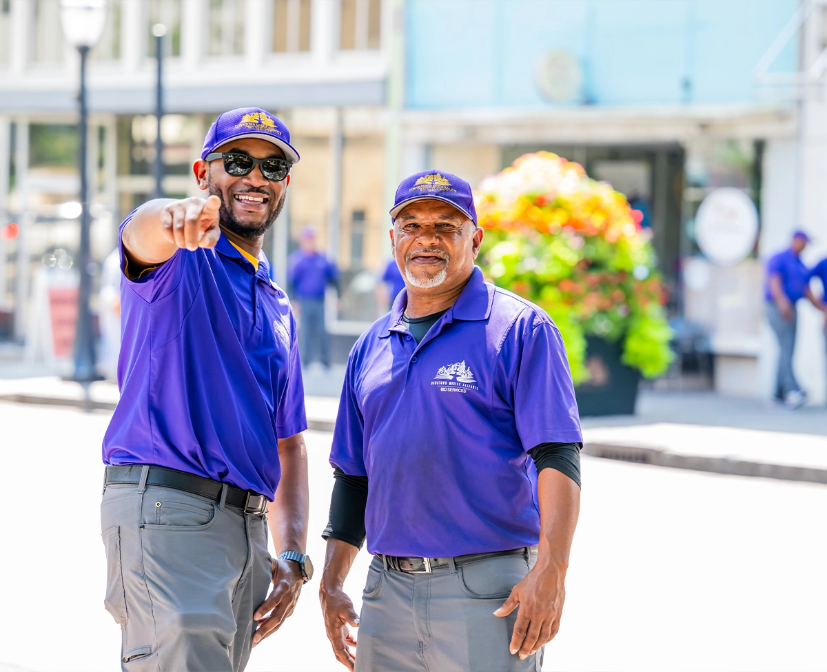Downtown Mobile Alliance BID Services Ambassadors pointing at camera and smiling for safety